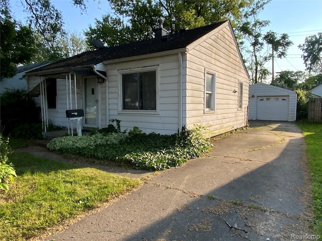 3255 Goodrich St, Ferndale, MI 48220 - bungalow-style home featuring concrete driveway, a detached garage, an outdoor structure, and a chimney