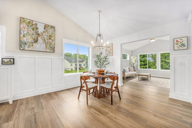 LOT166 Wren Ct, Caledonia, MI 49316 - dining space featuring a decorative wall, lofted ceiling, light wood-style flooring, a chandelier, and wainscoting