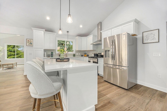LOT166 Wren Ct, Caledonia, MI 49316 - kitchen featuring stainless steel appliances, wall chimney range hood, white cabinetry, a center island, and light countertops