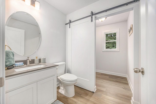 LOT166 Wren Ct, Caledonia, MI 49316 - bathroom with vanity, wood finished floors, toilet, and baseboards