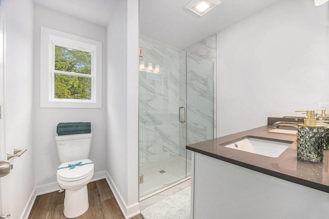 LOT166 Wren Ct, Caledonia, MI 49316 - full bath featuring vanity, toilet, a shower stall, wood finished floors, and baseboards