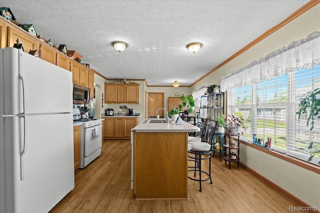 11091 Aspen Ct, South Lyon, MI 48178 - kitchen with white appliances, a sink, ornamental molding, light countertops, and light wood-type flooring