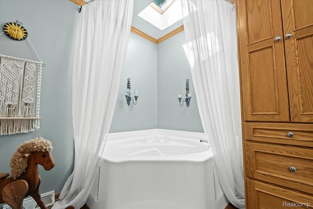 11091 Aspen Ct, South Lyon, MI 48178 - bathroom featuring a garden tub and a skylight