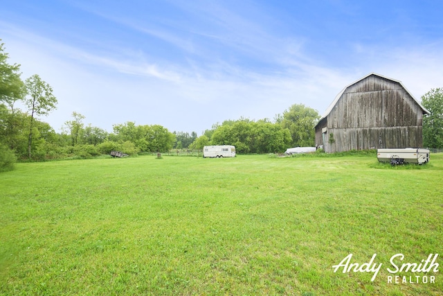 9386 N Vandecar Rd, Farwell, MI 48622 - view of grassy yard with a barn and an outbuilding