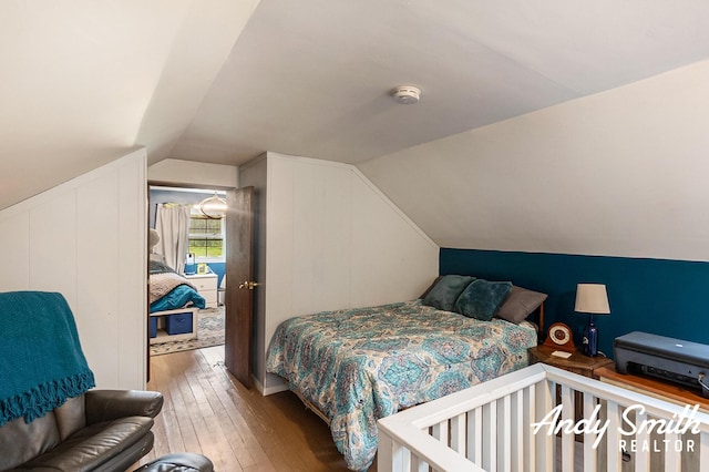 9386 N Vandecar Rd, Farwell, MI 48622 - bedroom featuring hardwood / wood-style floors and vaulted ceiling