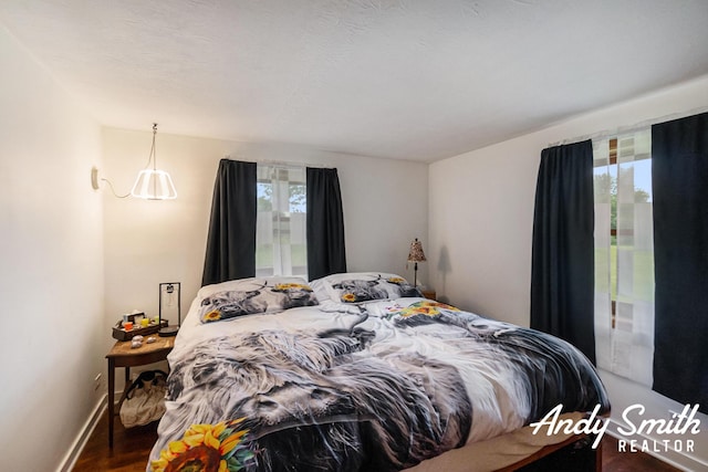 9386 N Vandecar Rd, Farwell, MI 48622 - bedroom featuring wood finished floors and baseboards