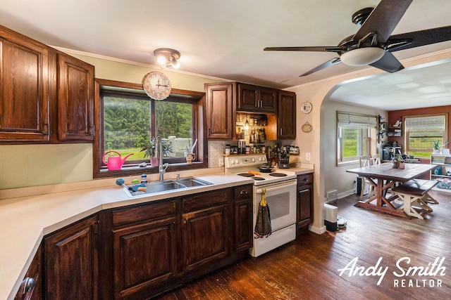 9386 N Vandecar Rd, Farwell, MI 48622 - kitchen featuring electric range, ceiling fan, dark wood finished floors, light countertops, and arched walkways