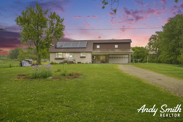 9386 N Vandecar Rd, Farwell, MI 48622 - traditional-style house with dirt driveway, a front yard, solar panels, and a garage
