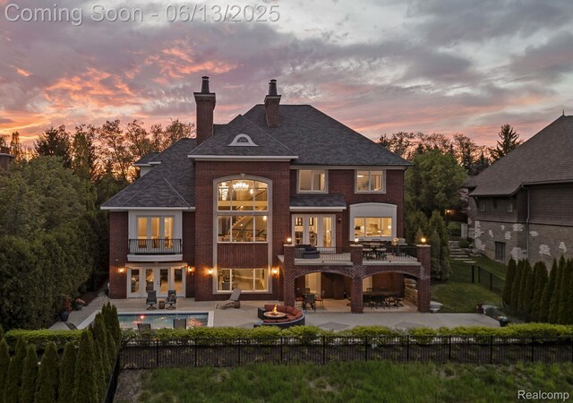 2750 Turtle Bluff Dr, Bloomfield Hills, MI 48302 - back of house with a balcony, french doors, a patio, a fenced backyard, and a chimney
