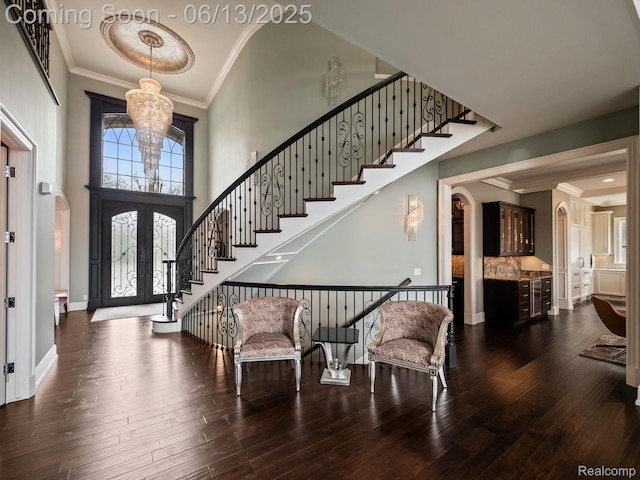 2750 Turtle Bluff Dr, Bloomfield Hills, MI 48302 - foyer featuring arched walkways, stairway, a chandelier, french doors, and ornamental molding