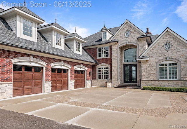 2750 Turtle Bluff Dr, Bloomfield Hills, MI 48302 - french country style house with stone siding, driveway, and french doors