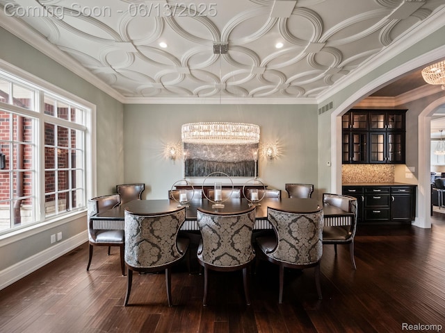 2750 Turtle Bluff Dr, Bloomfield Hills, MI 48302 - dining area featuring a chandelier, dark wood-style flooring, arched walkways, and plenty of natural light