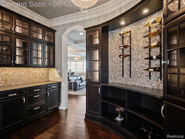 2750 Turtle Bluff Dr, Bloomfield Hills, MI 48302 - bar area featuring ornamental molding, arched walkways, backsplash, and dark wood-style floors