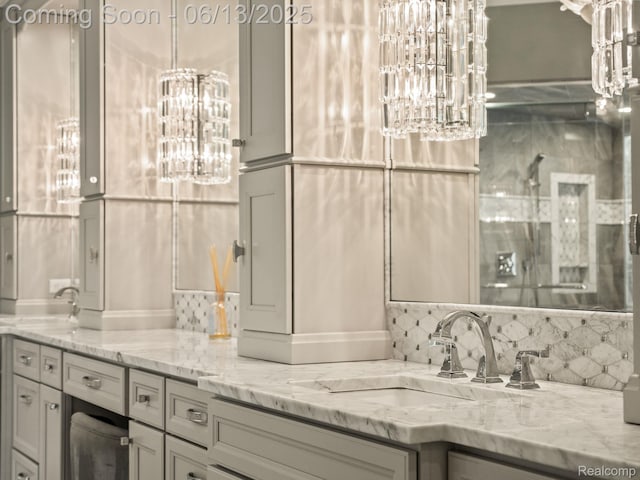 2750 Turtle Bluff Dr, Bloomfield Hills, MI 48302 - bathroom featuring a chandelier, tasteful backsplash, and double vanity