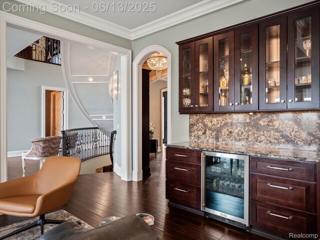 2750 Turtle Bluff Dr, Bloomfield Hills, MI 48302 - indoor dry bar featuring wine cooler, decorative backsplash, ornamental molding, dark wood-style floors, and arched walkways
