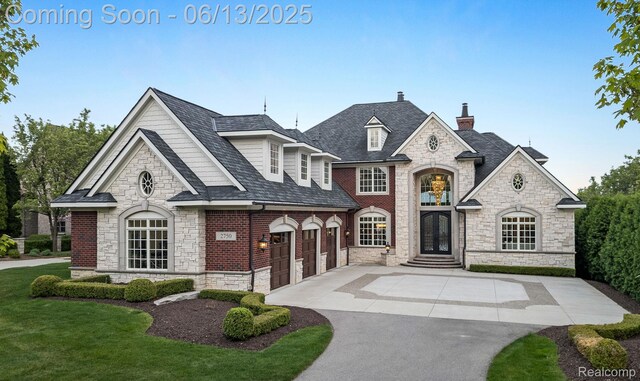 2750 Turtle Bluff Dr, Bloomfield Hills, MI 48302 - view of front of property featuring stone siding, driveway, a chimney, and a garage