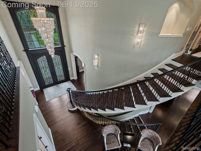 2750 Turtle Bluff Dr, Bloomfield Hills, MI 48302 - foyer entrance featuring arched walkways, french doors, stairway, wood finished floors, and a towering ceiling