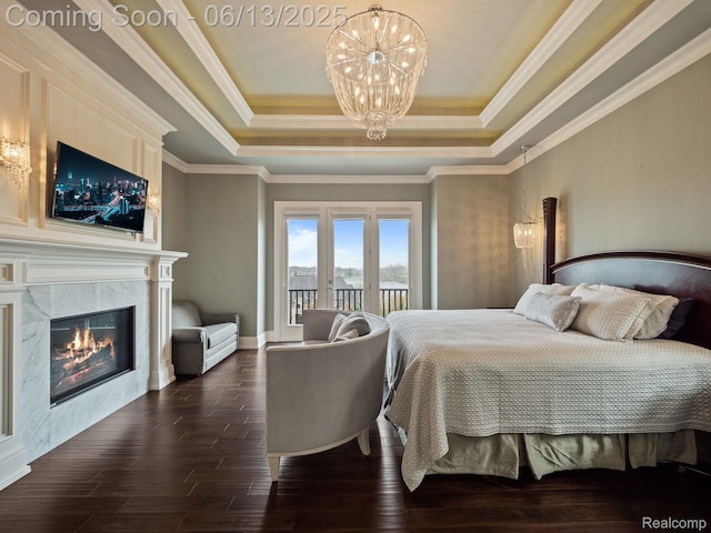 2750 Turtle Bluff Dr, Bloomfield Hills, MI 48302 - bedroom featuring a tray ceiling, a chandelier, access to outside, dark wood finished floors, and a premium fireplace