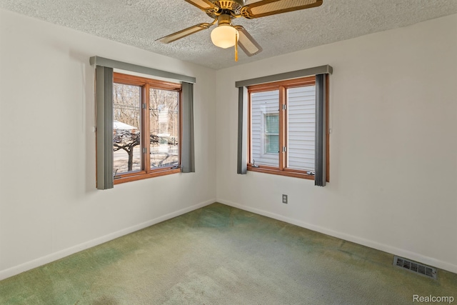 2830 N Duck Lake Rd, Highland, MI 48356 - carpeted empty room with baseboards, a ceiling fan, and a textured ceiling