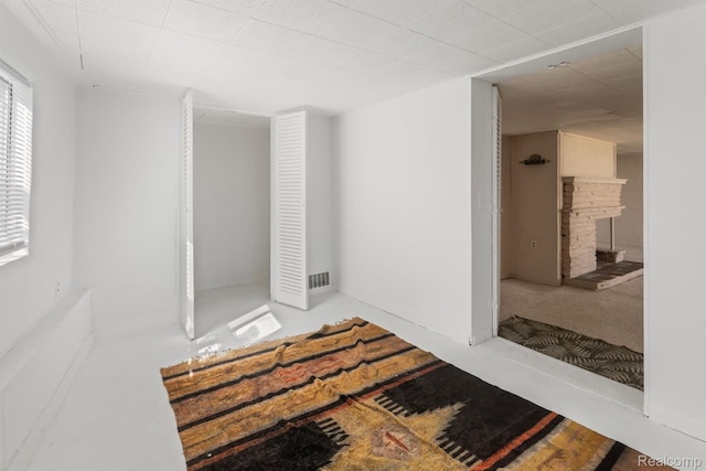 2830 N Duck Lake Rd, Highland, MI 48356 - unfurnished bedroom featuring a fireplace