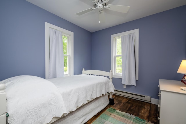 3619 Dearborn St, Coloma, MI 49038 - bedroom featuring a baseboard radiator, wood finished floors, multiple windows, and a ceiling fan