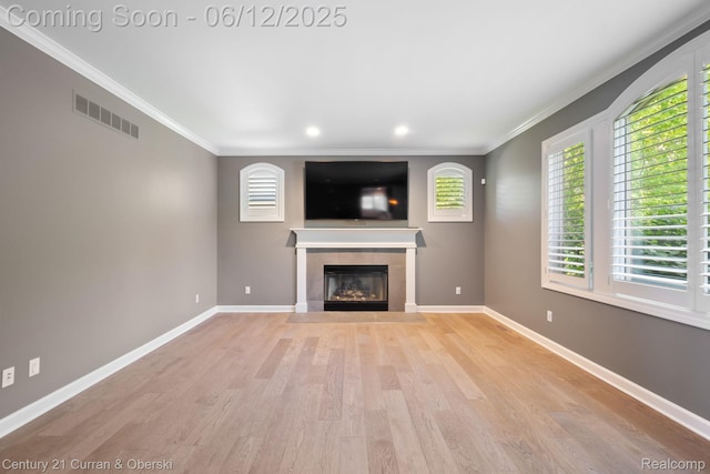 44251 Deep Hollow Cir, Northville, MI 48168 - unfurnished living room with a tile fireplace, light wood-style floors, crown molding, baseboards, and recessed lighting