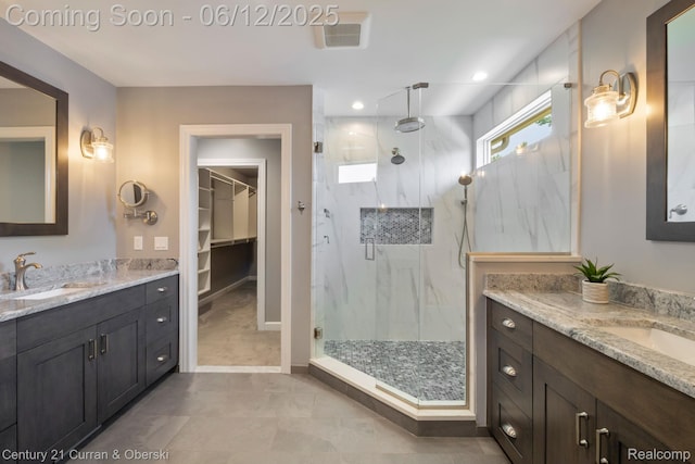 44251 Deep Hollow Cir, Northville, MI 48168 - bathroom featuring a marble finish shower, two vanities, a spacious closet, and recessed lighting