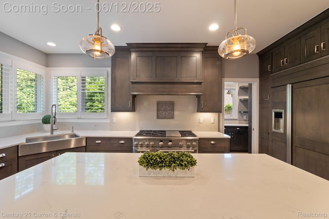 44251 Deep Hollow Cir, Northville, MI 48168 - kitchen with a sink, high quality appliances, dark brown cabinets, decorative light fixtures, and recessed lighting