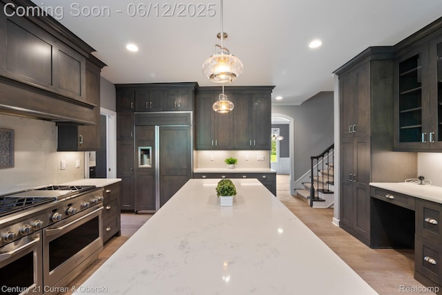 44251 Deep Hollow Cir, Northville, MI 48168 - kitchen with premium appliances, decorative light fixtures, light wood-style flooring, dark brown cabinets, and recessed lighting