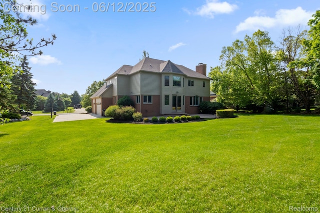44251 Deep Hollow Cir, Northville, MI 48168 - view of side of property featuring a chimney, driveway, a garage, and a yard