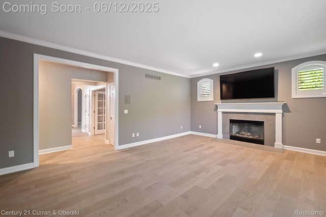 44251 Deep Hollow Cir, Northville, MI 48168 - unfurnished living room with crown molding, a fireplace, light wood-style flooring, baseboards, and recessed lighting