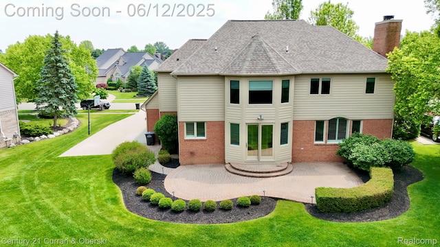 44251 Deep Hollow Cir, Northville, MI 48168 - rear view of house featuring brick siding, a patio, and a lawn