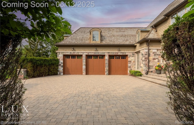 2937 Turtle Pond Ct, Bloomfield Hills, MI 48302 - garage at dusk with decorative driveway