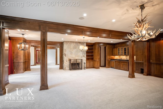 2937 Turtle Pond Ct, Bloomfield Hills, MI 48302 - unfurnished living room with wood walls, light carpet, a fireplace, a chandelier, and ornamental molding