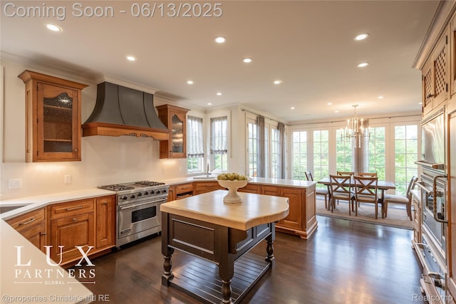 2937 Turtle Pond Ct, Bloomfield Hills, MI 48302 - kitchen with luxury stove, custom exhaust hood, a peninsula, recessed lighting, and healthy amount of natural light