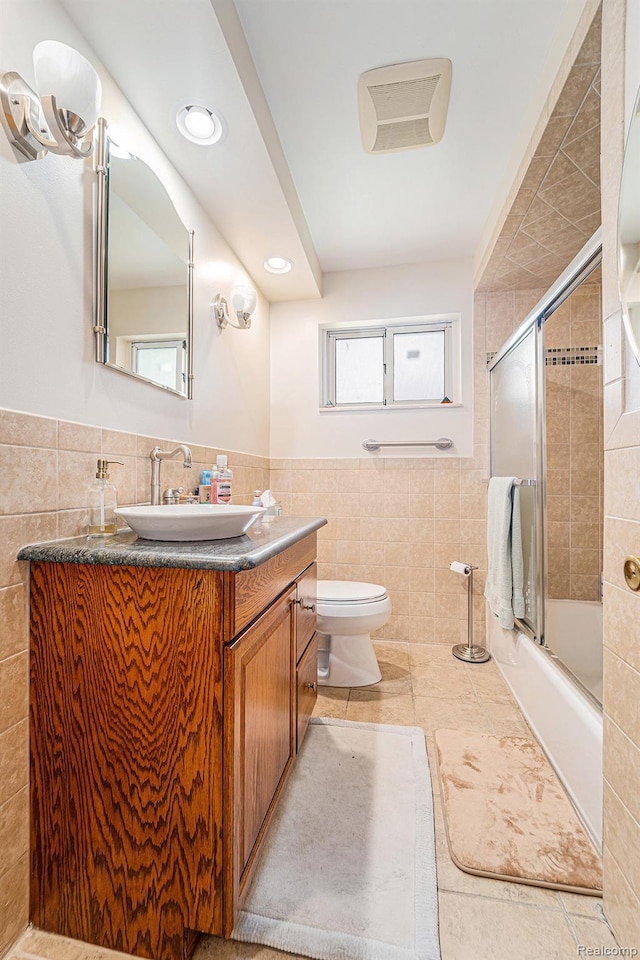 30060 Eastfield St, Farmington Hills, MI 48334 - full bath featuring tile walls, vanity, bath / shower combo with glass door, tile patterned floors, and wainscoting