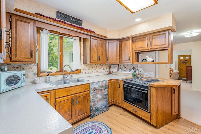 3077 Edson St, Coleman, MI 48618 - kitchen featuring a sink, electric range oven, light countertops, and brown cabinets
