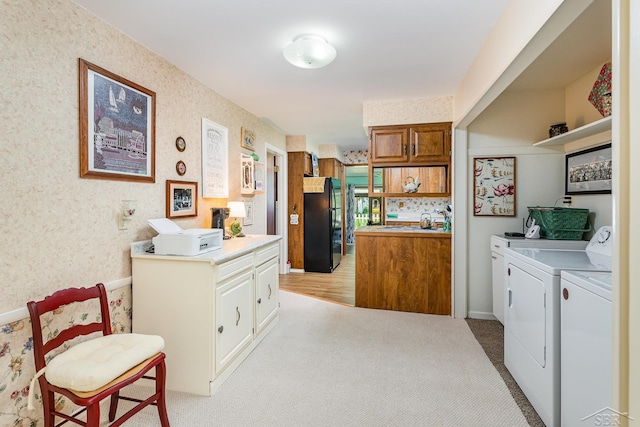 3077 Edson St, Coleman, MI 48618 - kitchen with freestanding refrigerator, washer and clothes dryer, brown cabinetry, light carpet, and open shelves