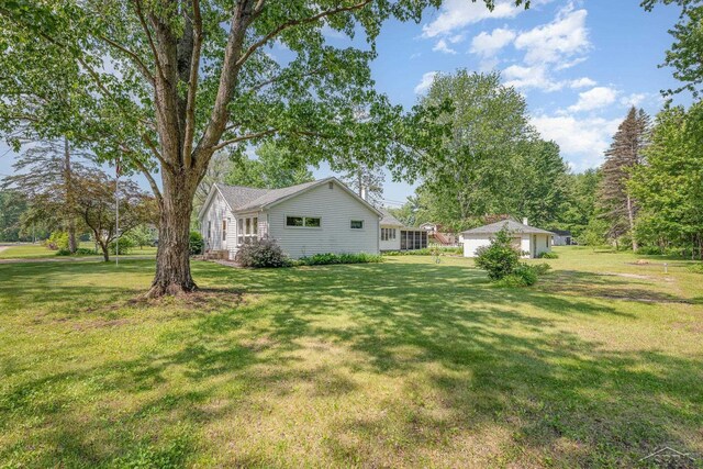 3077 Edson St, Coleman, MI 48618 - view of green lawn with a garage