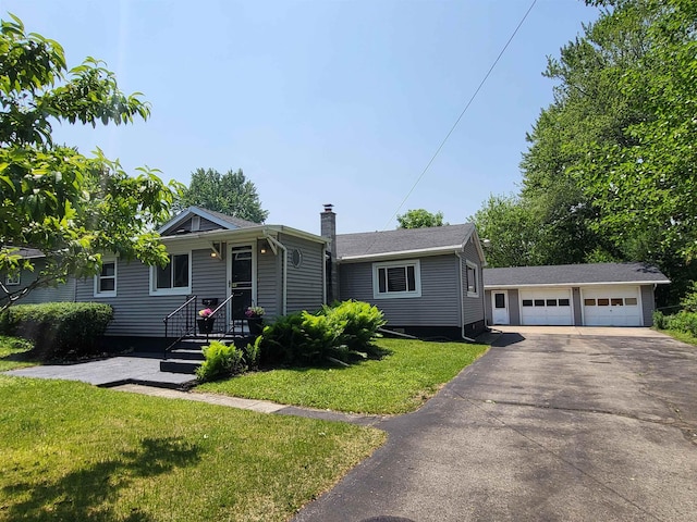 1010 S Pearce St, Owosso, MI 48867 - view of front facade with a garage, a chimney, an outdoor structure, and a front lawn