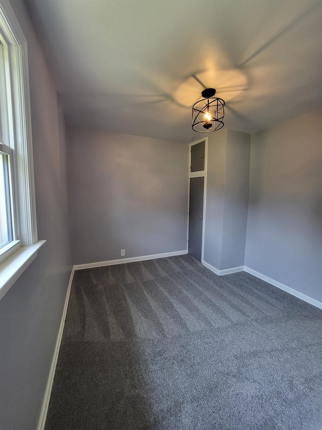 1010 S Pearce St, Owosso, MI 48867 - empty room featuring dark carpet and baseboards