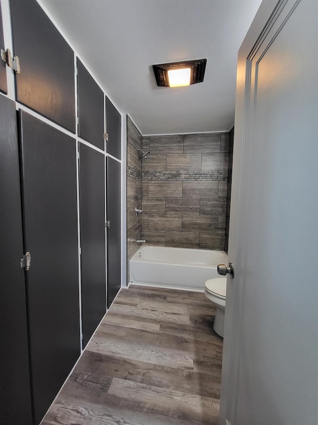 1010 S Pearce St, Owosso, MI 48867 - full bathroom with toilet, bathtub / shower combination, and wood finished floors