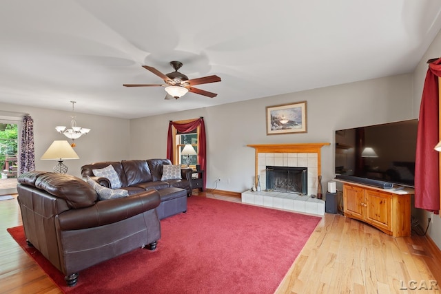 1377 Maplewood Dr St, Saline, MI 48176 - living area with light wood-style floors, ceiling fan, a fireplace, and baseboards