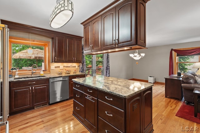 1377 Maplewood Dr St, Saline, MI 48176 - kitchen featuring dishwasher, a sink, light wood-type flooring, and healthy amount of natural light