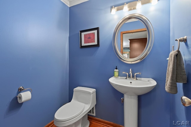 1377 Maplewood Dr St, Saline, MI 48176 - half bathroom featuring toilet, wood finished floors, ornamental molding, and a sink