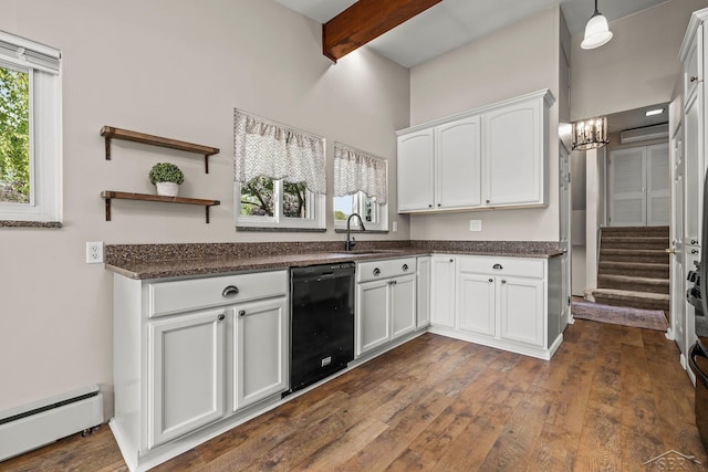 1449 Sauk Ln, Saginaw, MI 48638 - kitchen with black dishwasher, baseboard heating, beamed ceiling, white cabinets, and a chandelier