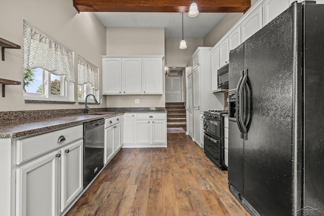 1449 Sauk Ln, Saginaw, MI 48638 - kitchen featuring black appliances, white cabinets, dark wood-type flooring, dark countertops, and pendant lighting