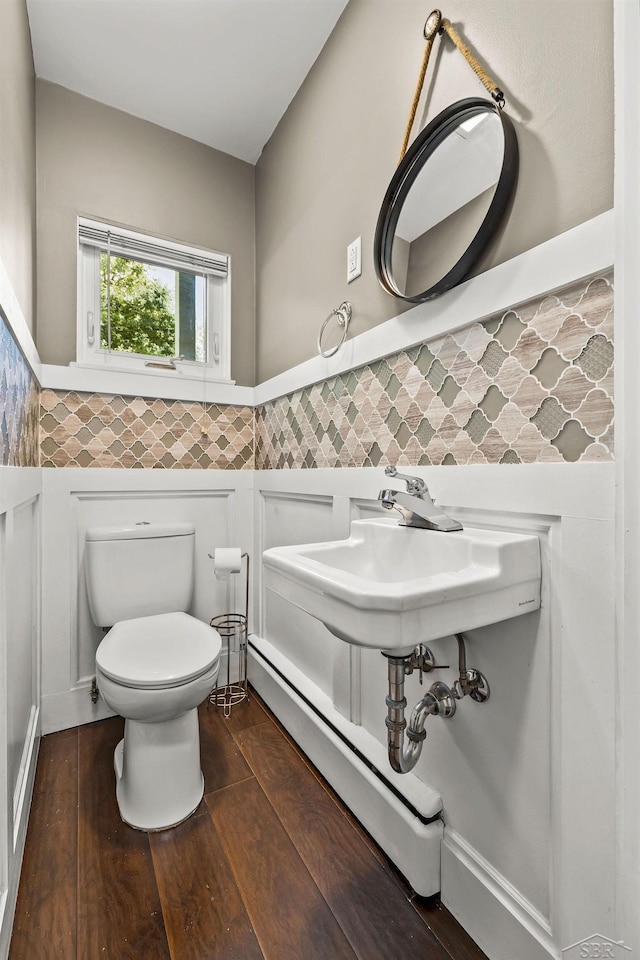 1449 Sauk Ln, Saginaw, MI 48638 - half bath featuring a wainscoted wall, tile walls, and wood finished floors