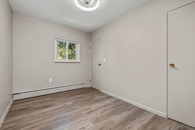 1449 Sauk Ln, Saginaw, MI 48638 - unfurnished room with baseboard heating and wood finished floors