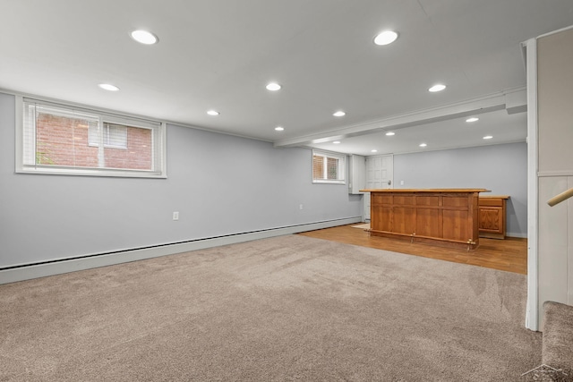 1449 Sauk Ln, Saginaw, MI 48638 - below grade area featuring light carpet, bar, a baseboard heating unit, recessed lighting, and light wood-style flooring